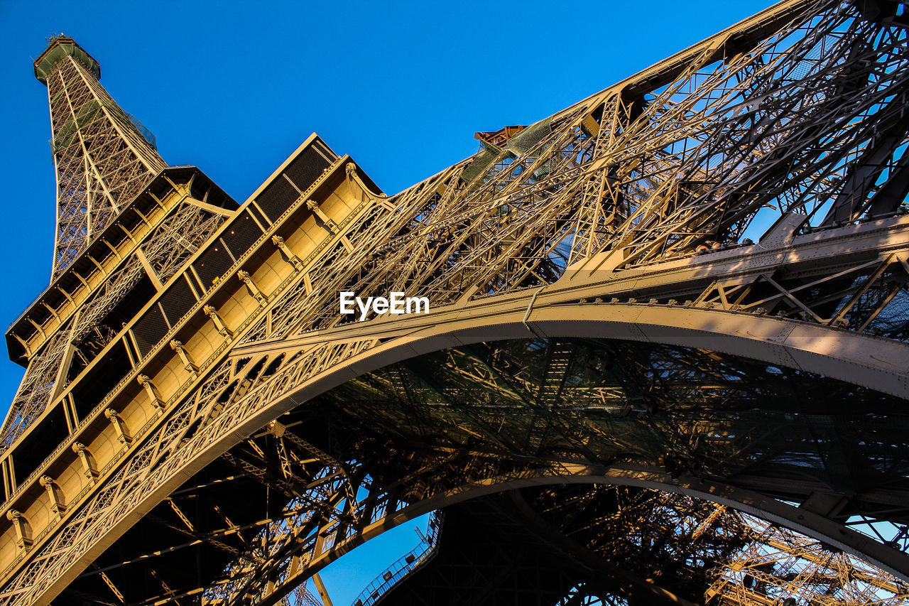 Low angle view of bridge against blue sky