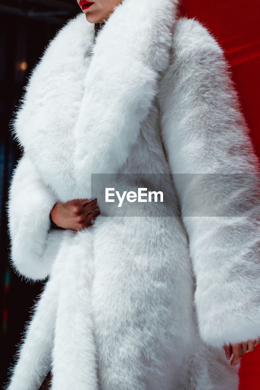 Fashion details of a white fluffy winter fur coat. winter women's casual fashion