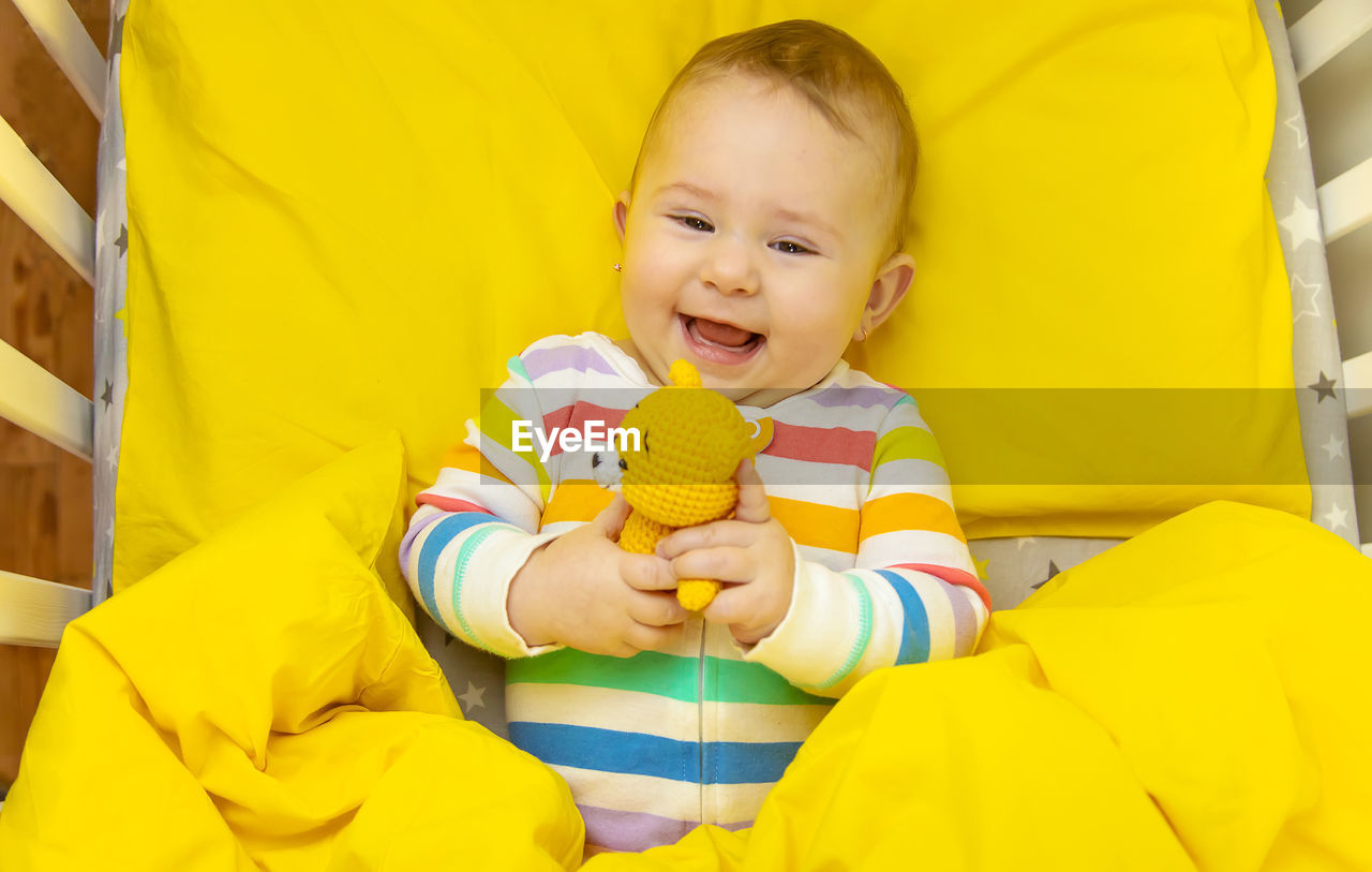 portrait of cute baby girl sleeping on bed at home