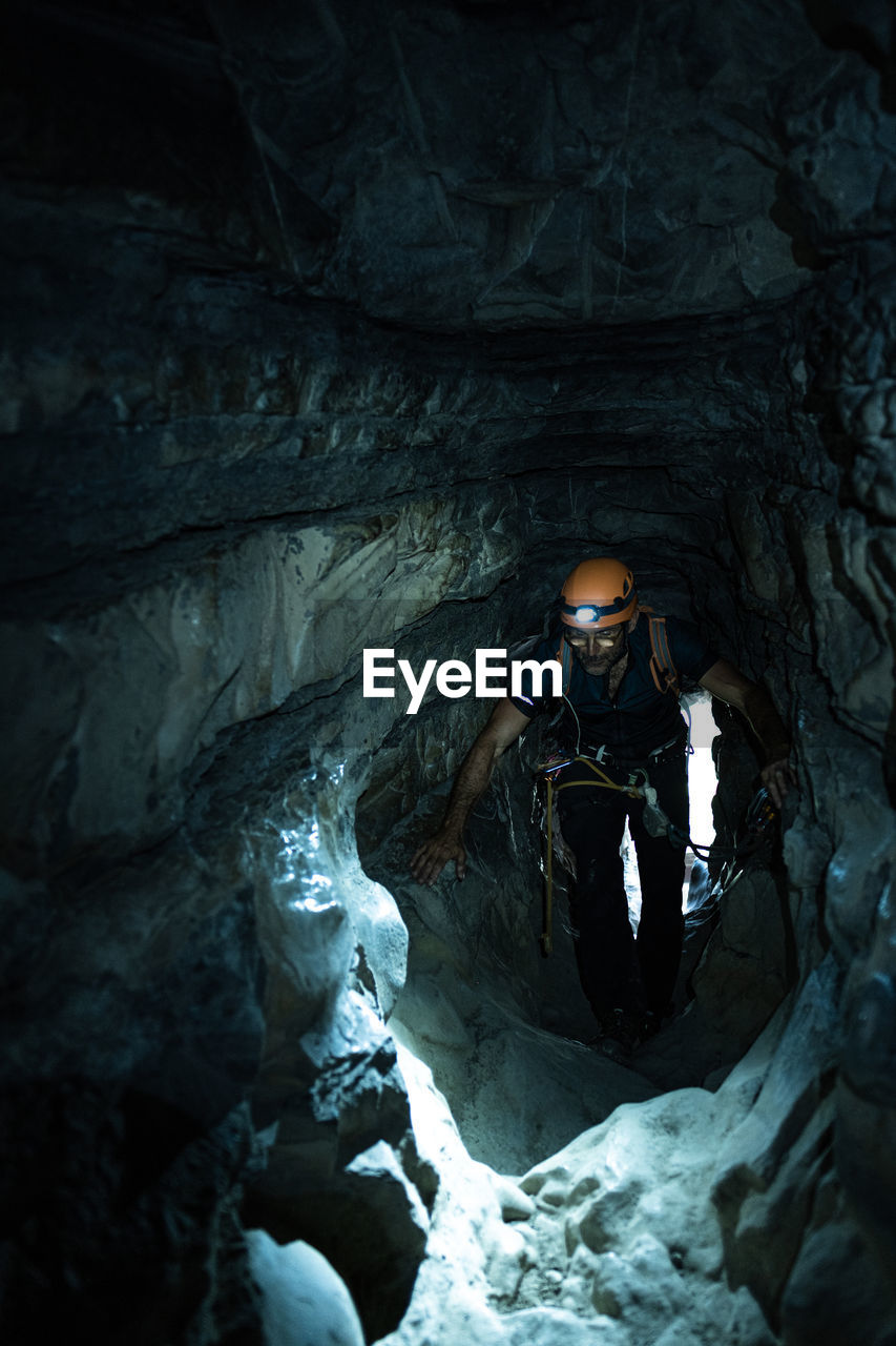 Man with climbing equipment inside a cave