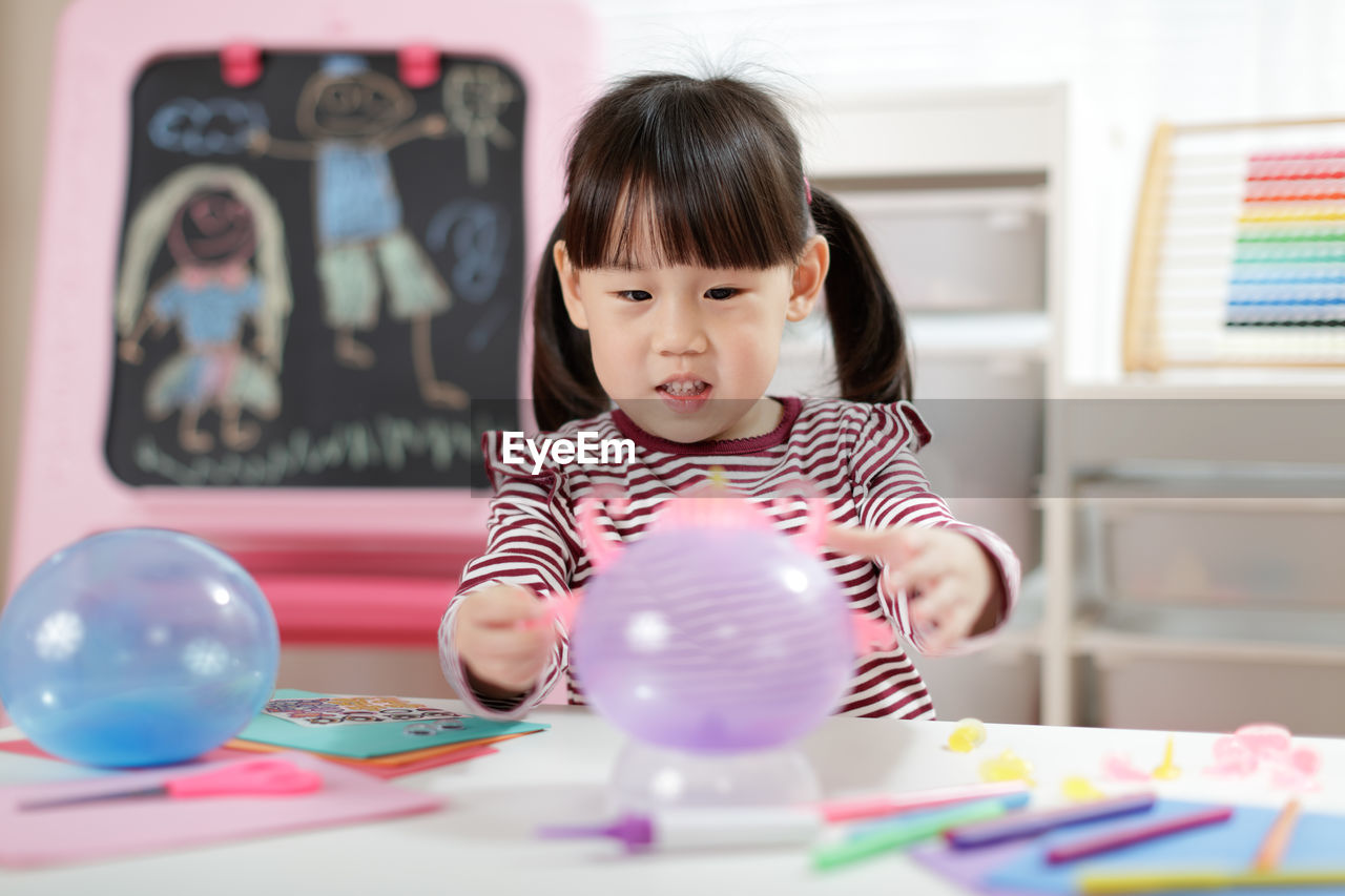 Young girl making craft for homeschooling 