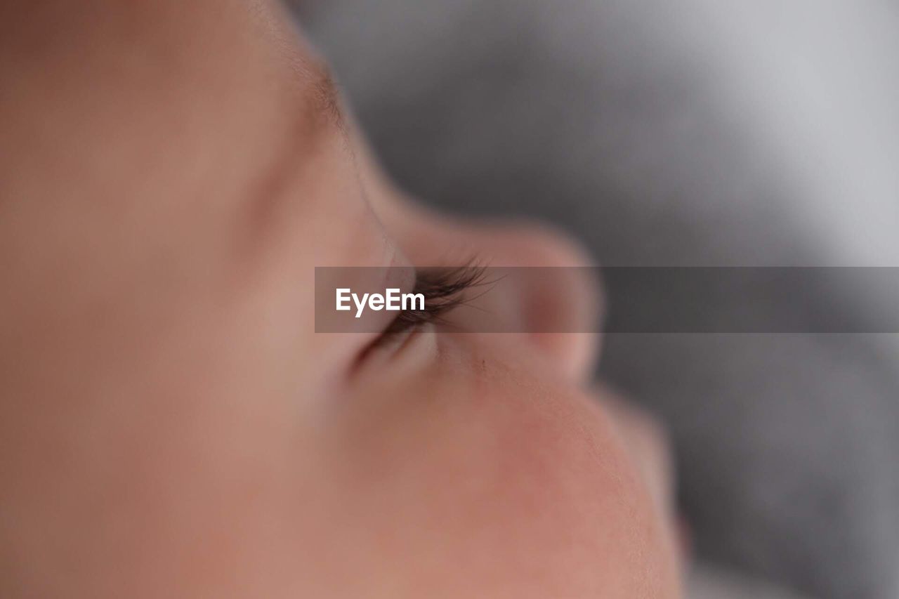 Close-up of baby girl sleeping on bed