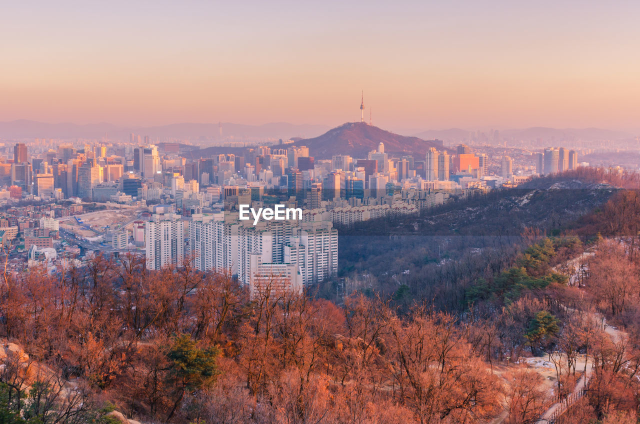 Aerial view of cityscape against sky during autumn