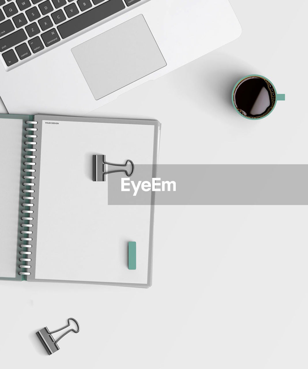 Directly above shot of laptop with coffee cup and diary on table