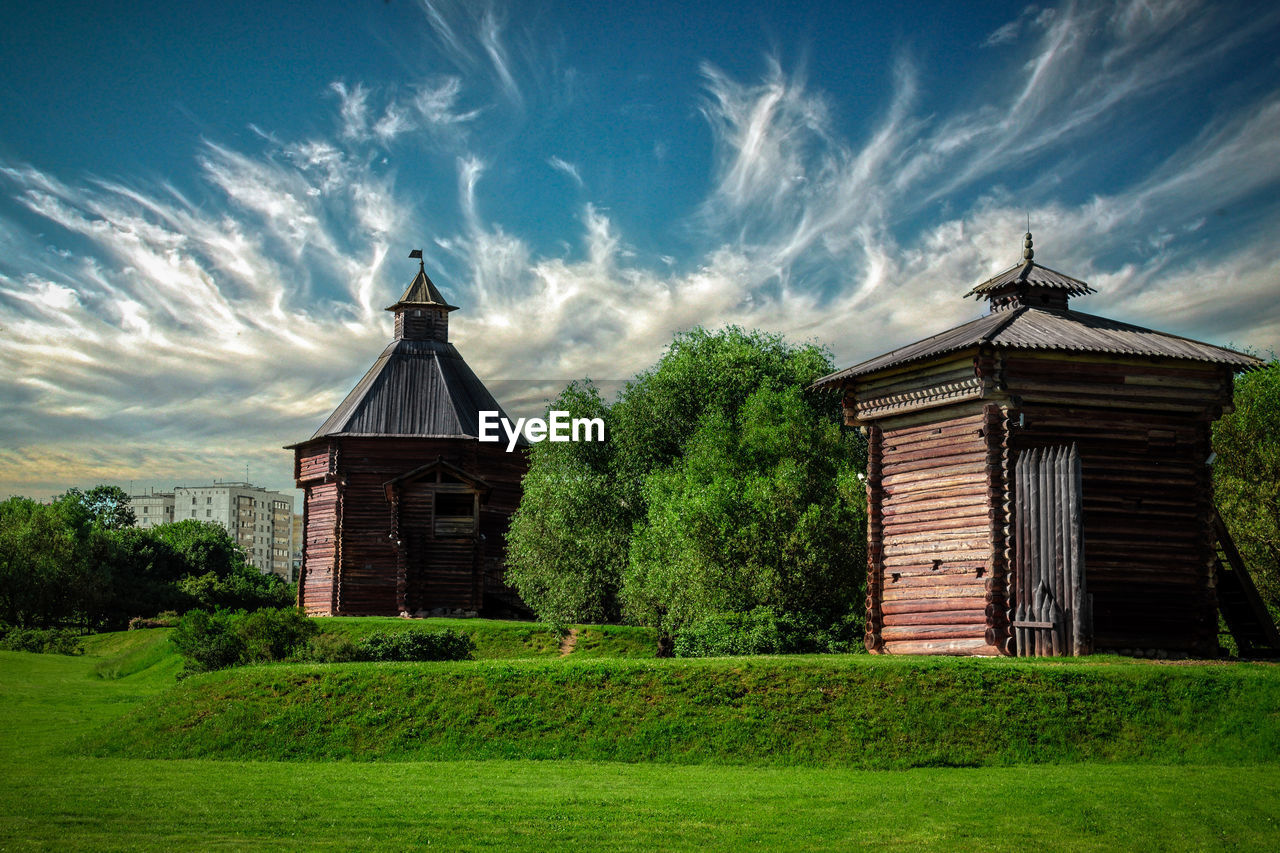 Built structure on field against sky