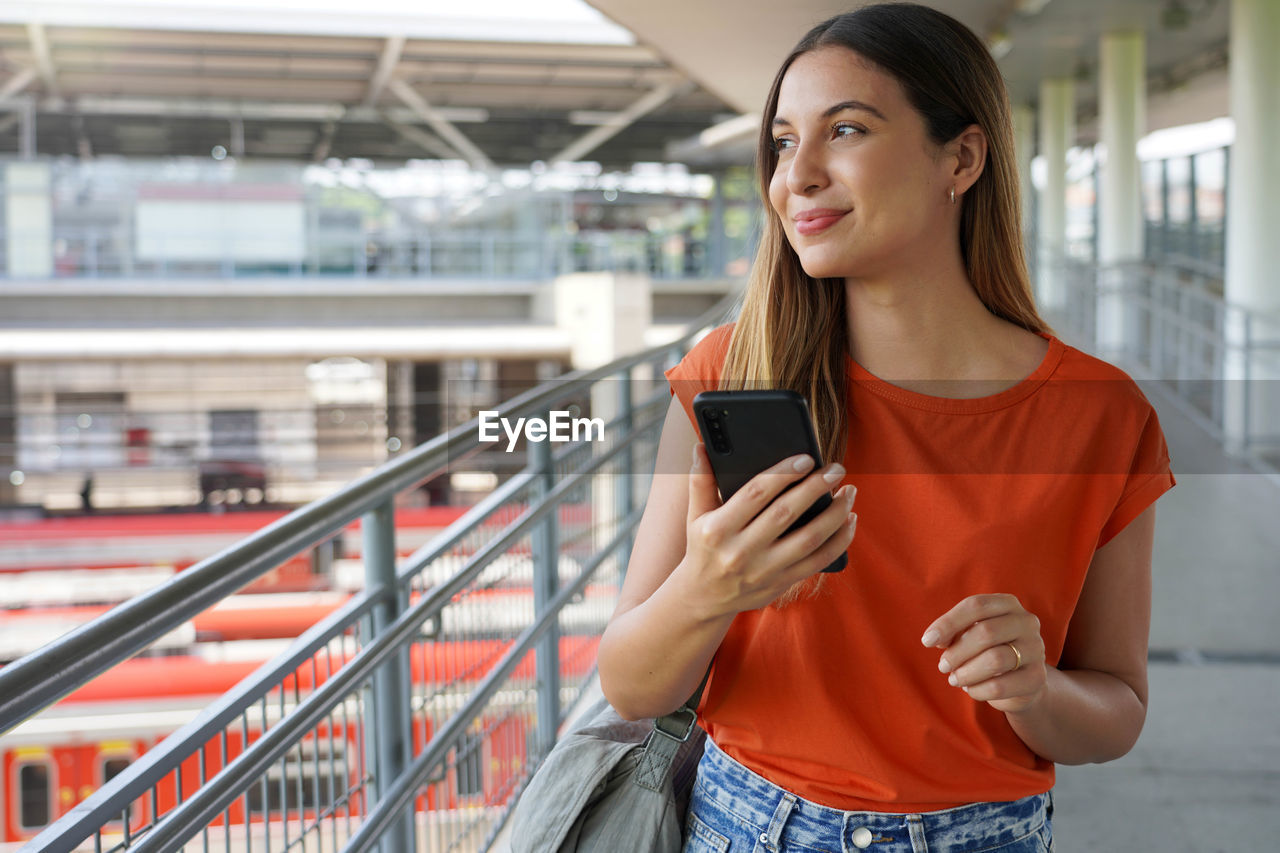 Confiedent businesswoman walking holding smartphone in metro station of sao paulo, brazil. 