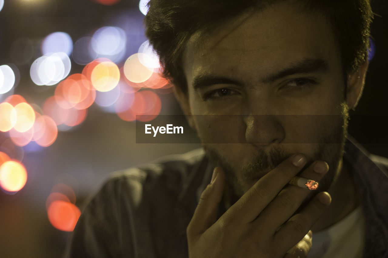 Close-up portrait of man smoking