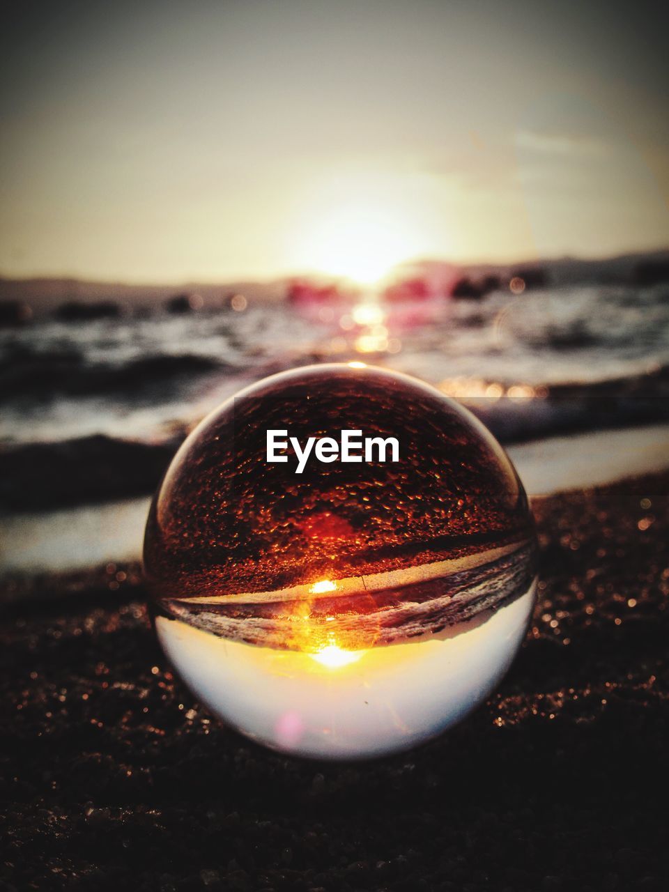 CLOSE-UP OF CRYSTAL BALL ON BEACH