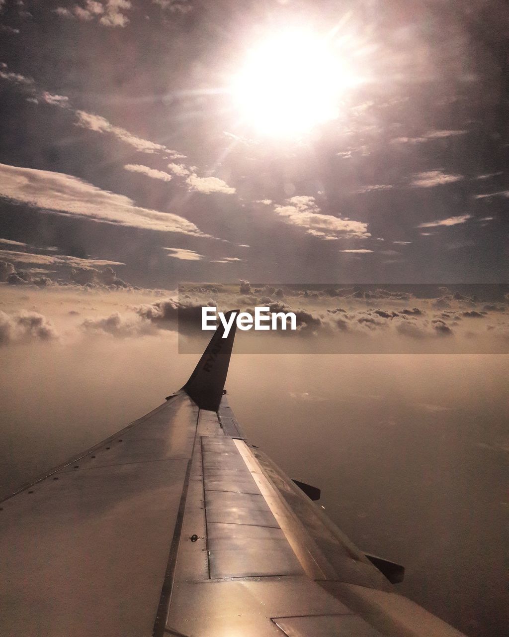 AIRPLANE WING AGAINST SKY