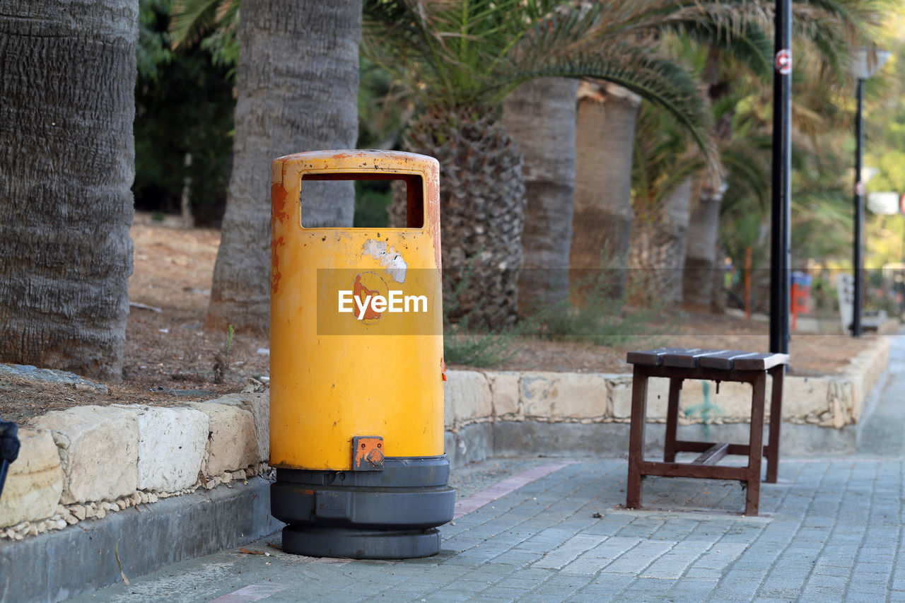 CLOSE-UP OF YELLOW BOX ON FOOTPATH