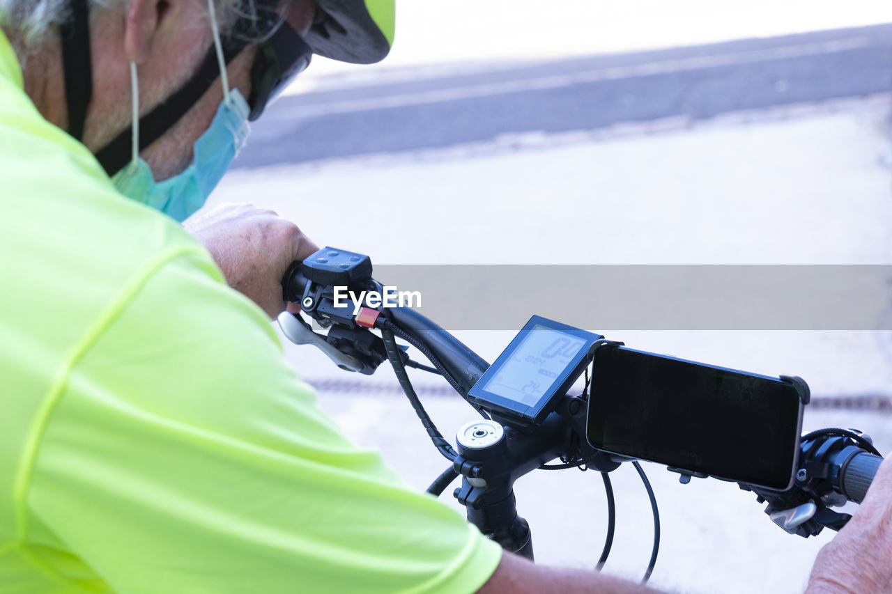 Close-up of senior man riding bicycle outdoors