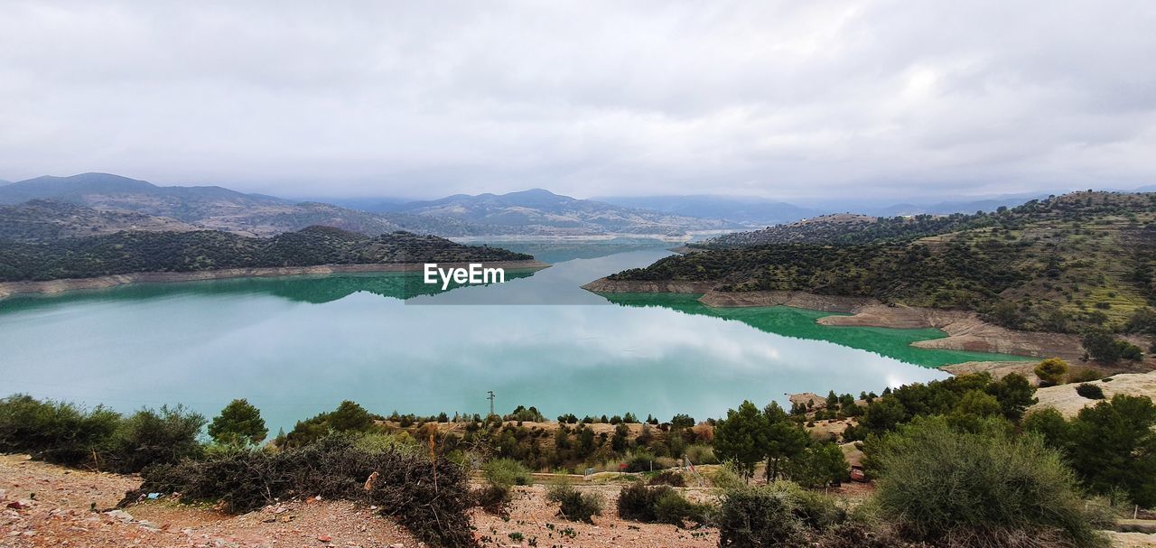 Panoramic view of lake and mountains against sky