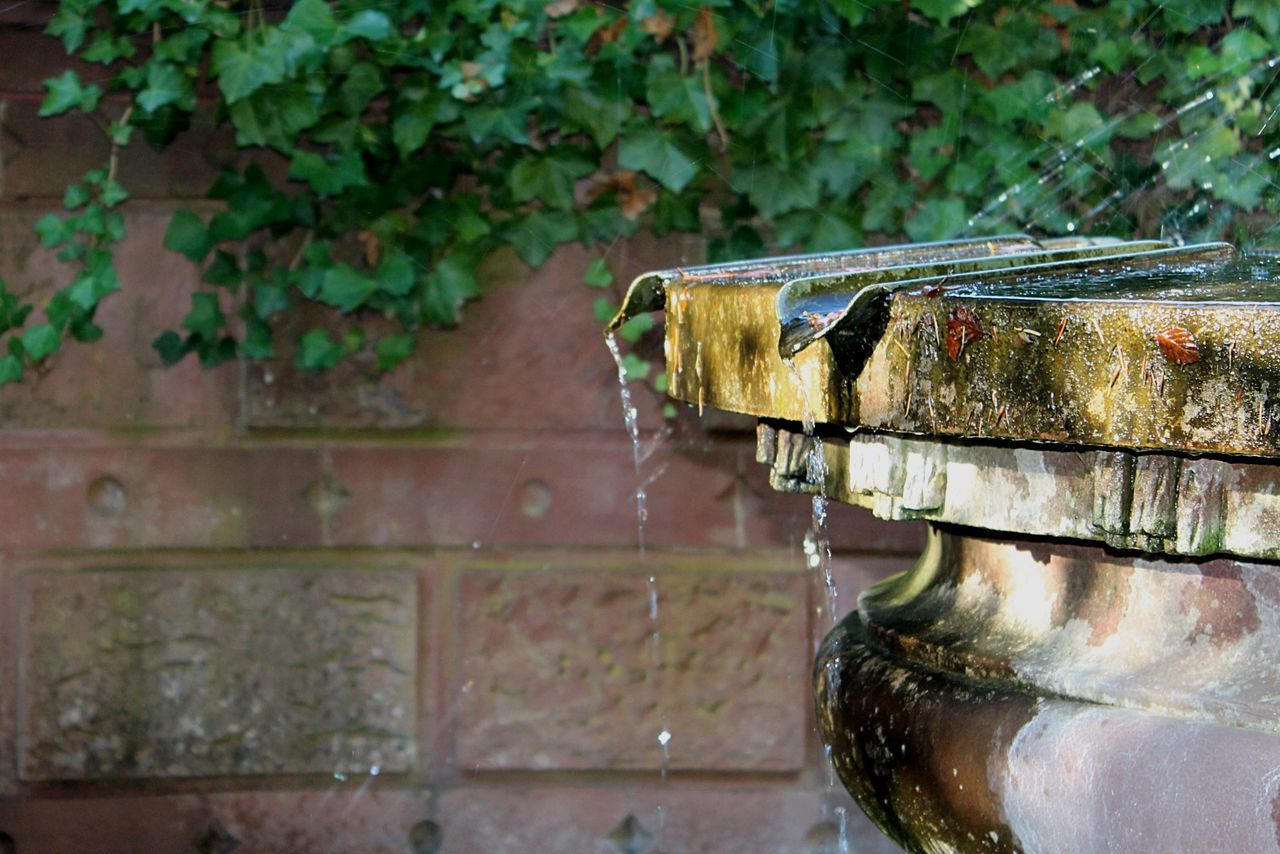 Close-up of cropped fountain against wall