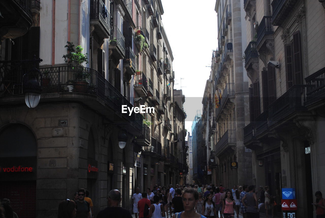 PEOPLE ON STREET IN FRONT OF BUILDING