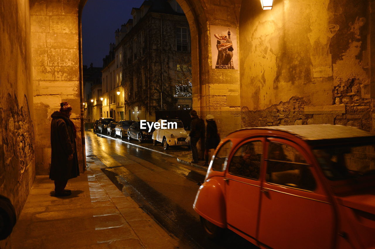 WOMAN IN ILLUMINATED CITY AT NIGHT