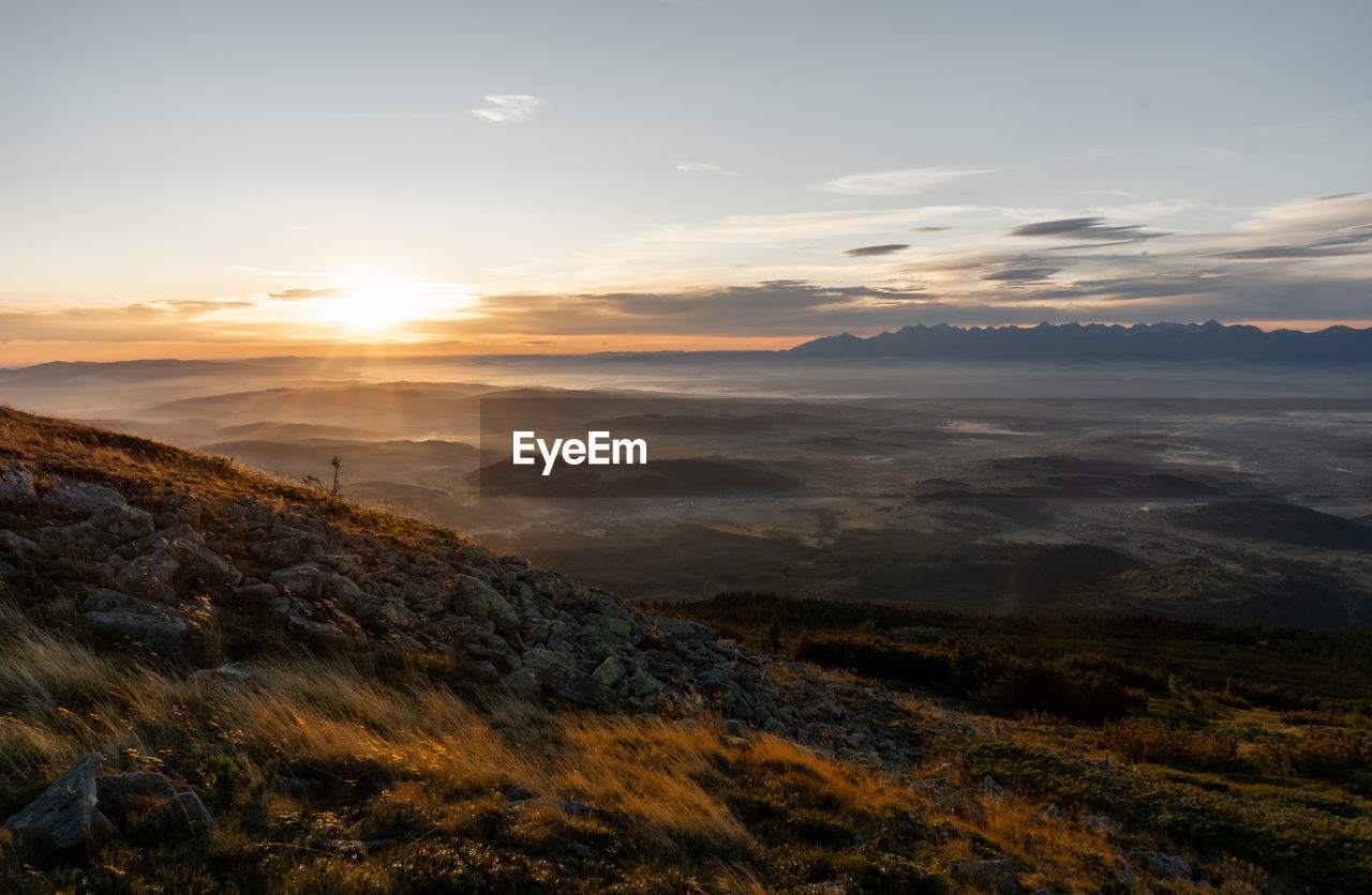 Scenic view of landscape against sky during sunset