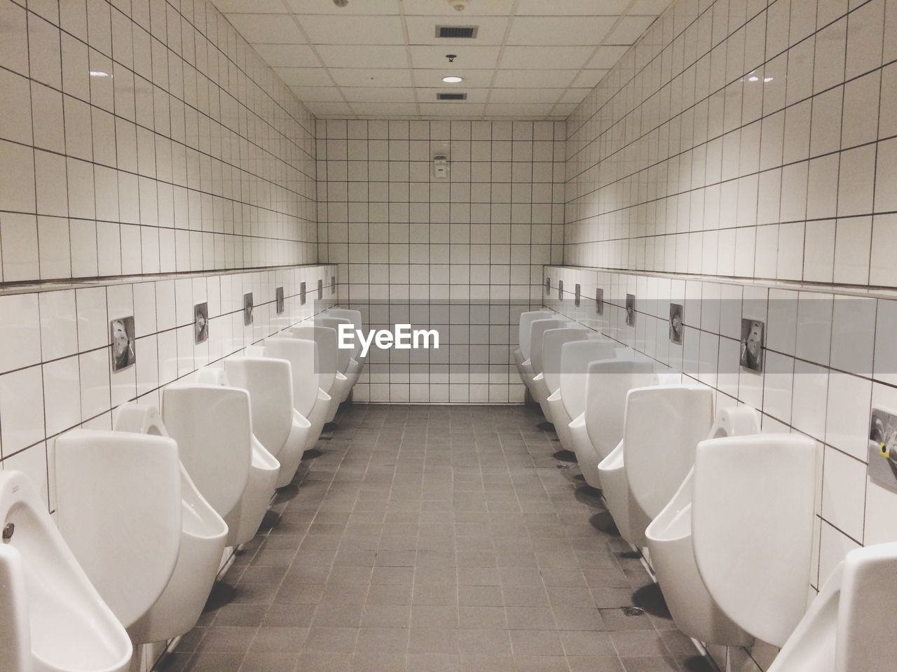 Urinals in illuminated public restroom