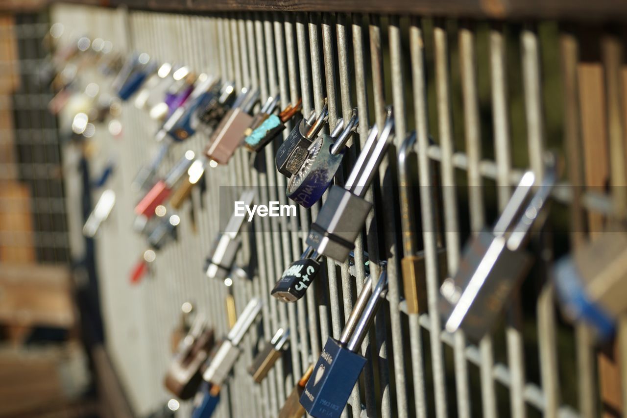 Close-up of padlocks on railing