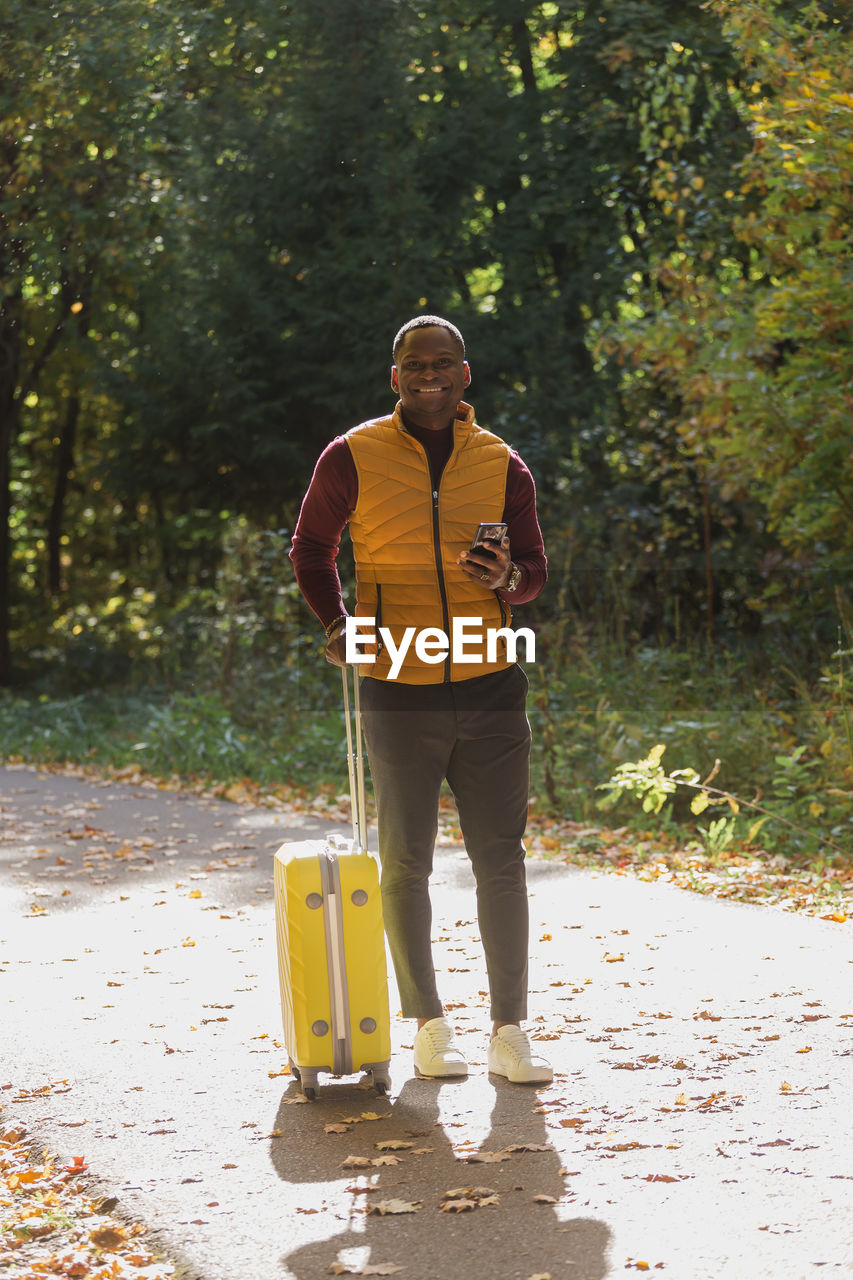 rear view of man walking on footpath in forest