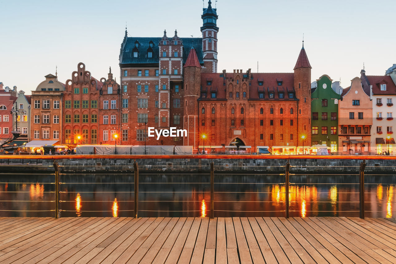 Facades of old medieval houses on the promenade in gdansk city. poland. wooden pier