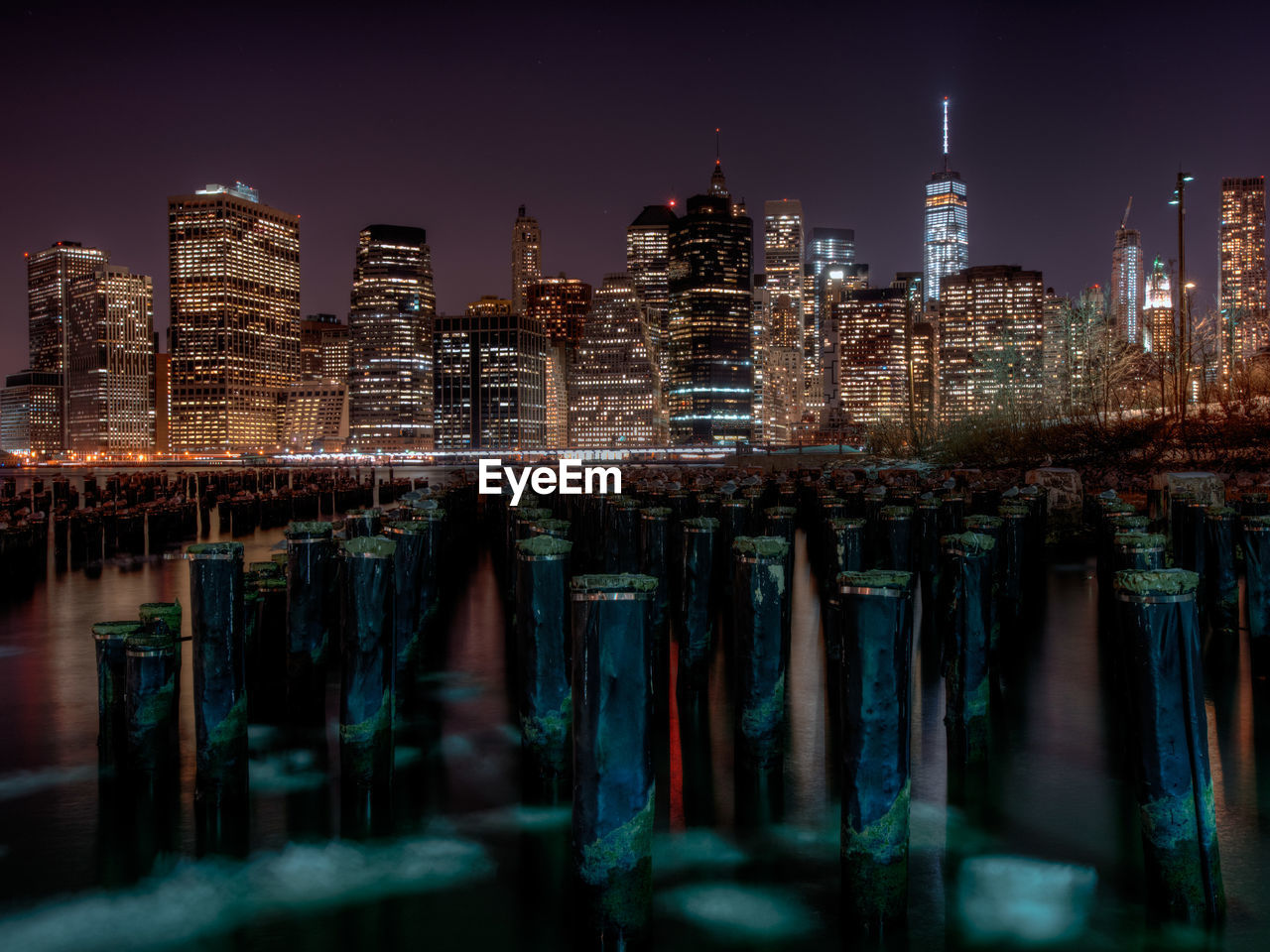 Illuminated skyline reflecting in still water