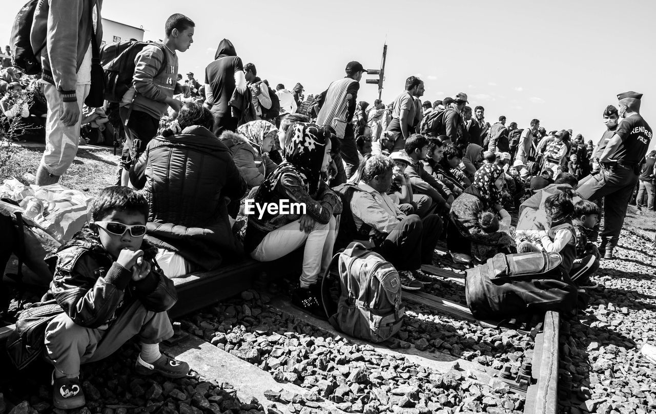 large group of people, real people, men, outdoors, crowd, day, sitting, togetherness, women, sky, adult, people