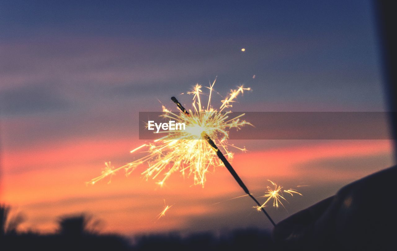 Low angle view of firework display at night