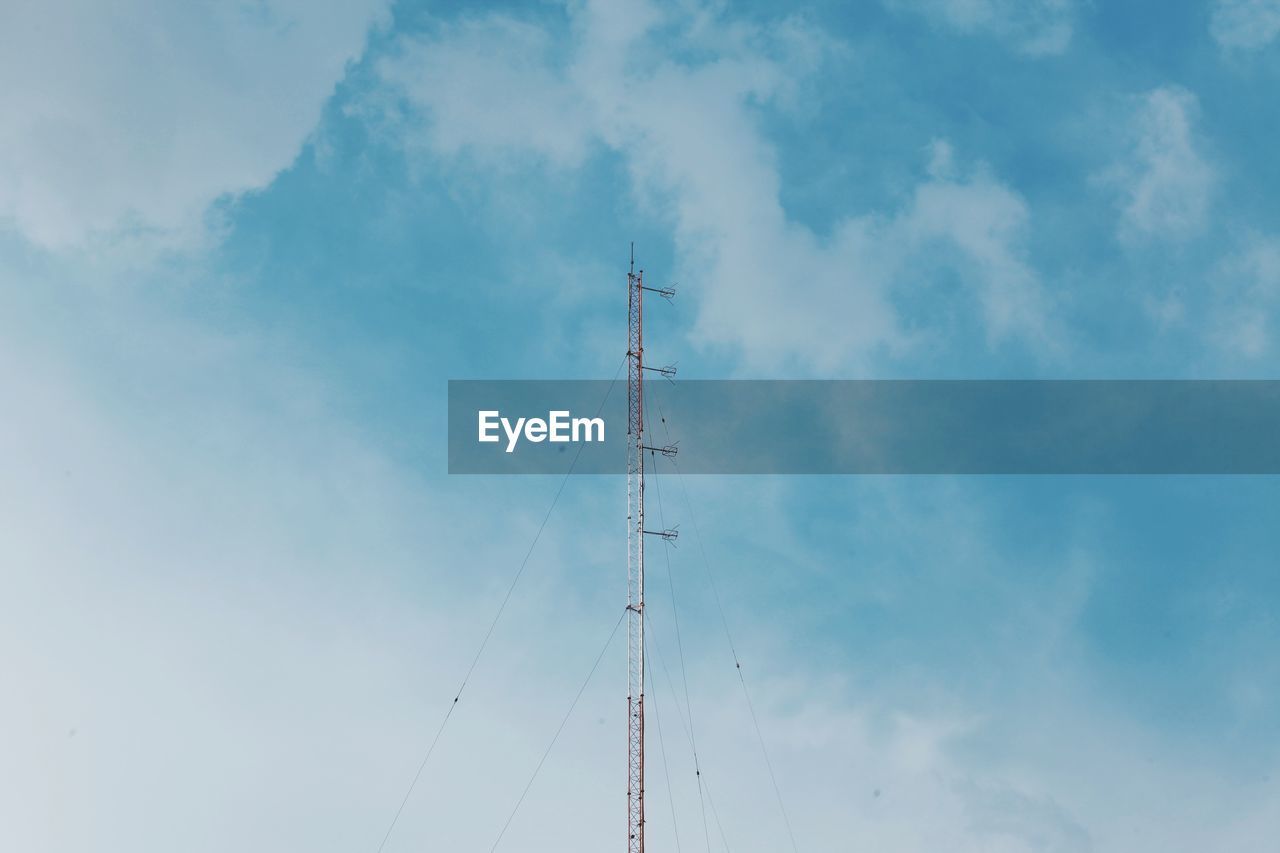 Low angle view of communications tower against sky