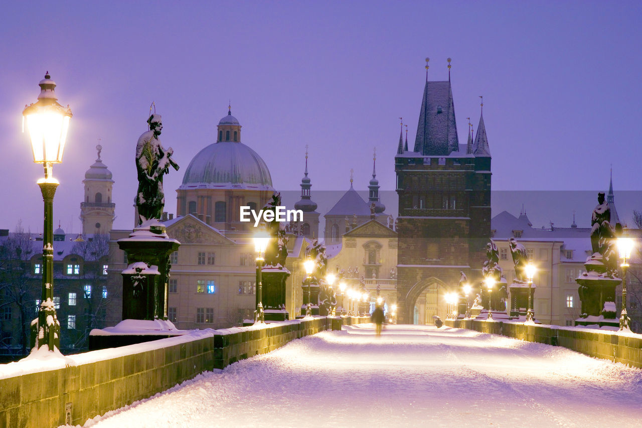 Illuminated church in city at night during winter