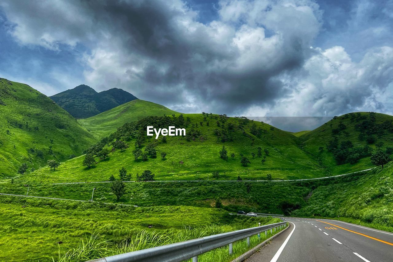 high angle view of road leading towards mountains against sky