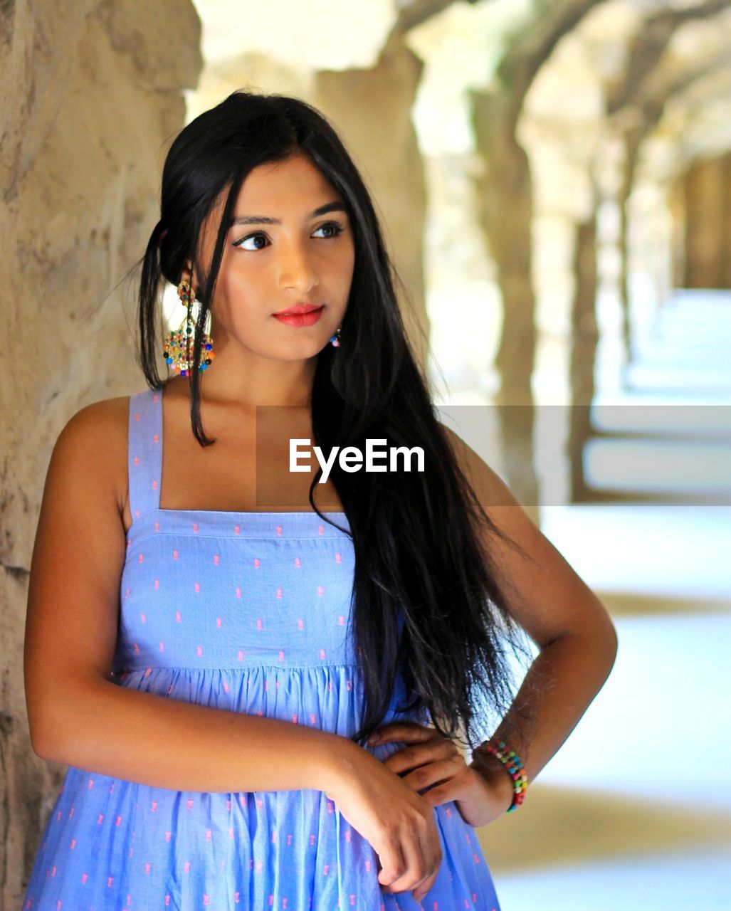 Beautiful young woman standing at corridor
