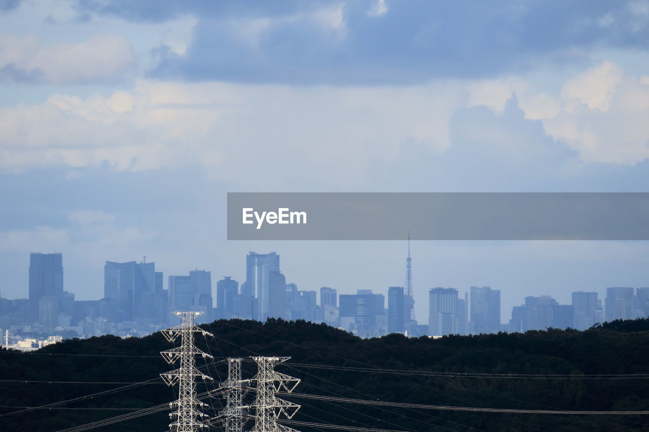 Skyscrapers against cloudy sky