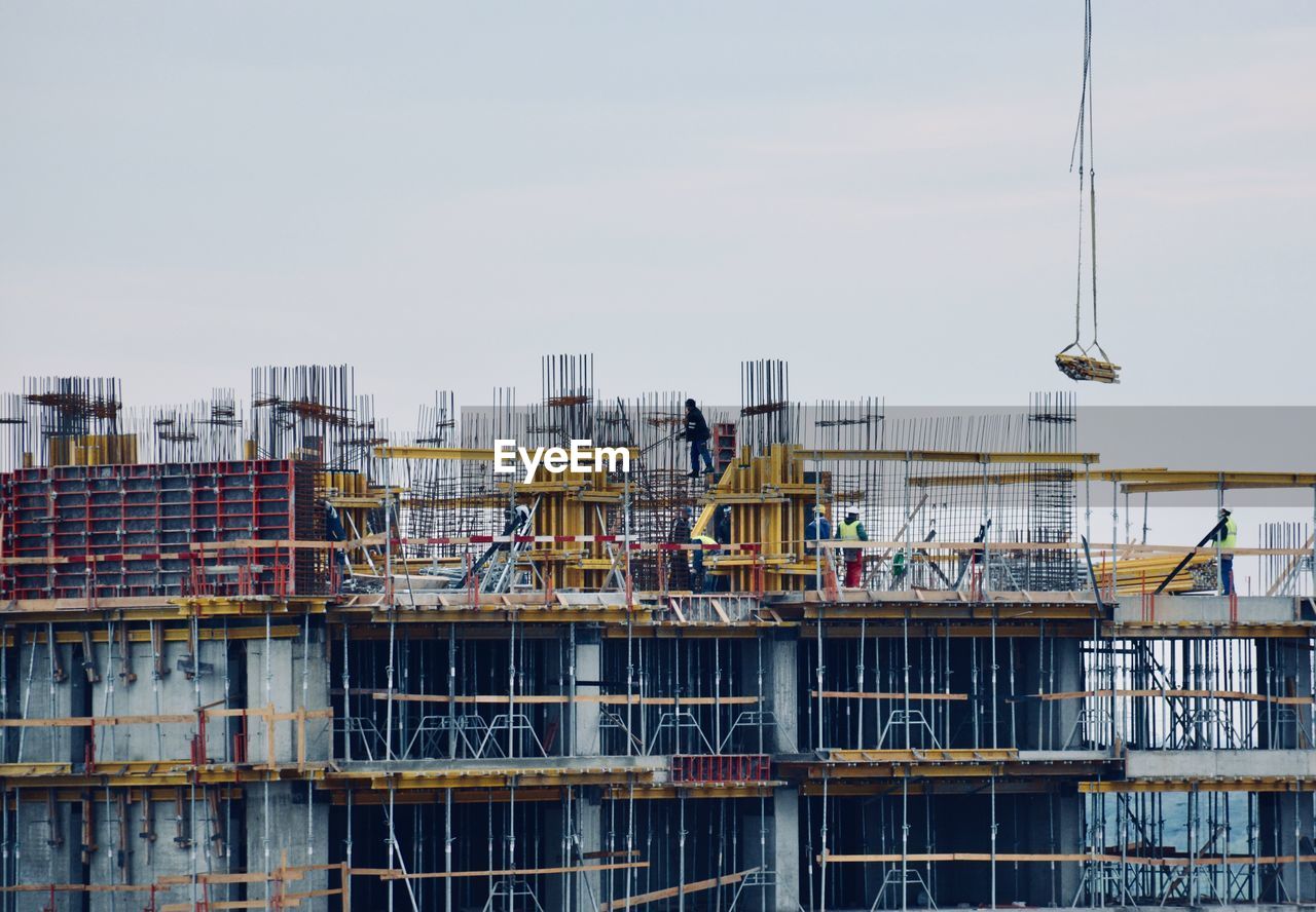 Construction site in city against sky