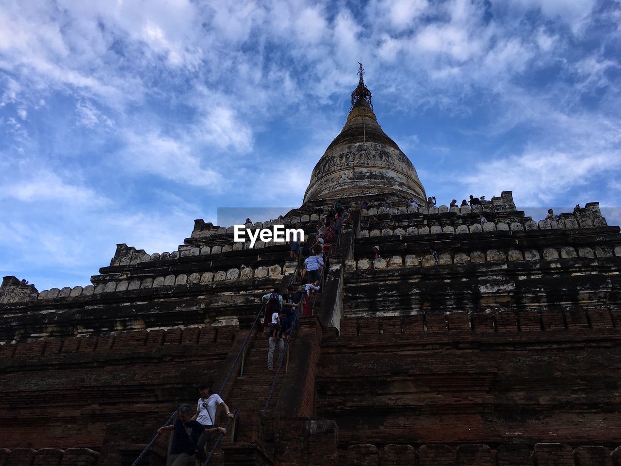 LOW ANGLE VIEW OF TOURIST VISITING TEMPLE