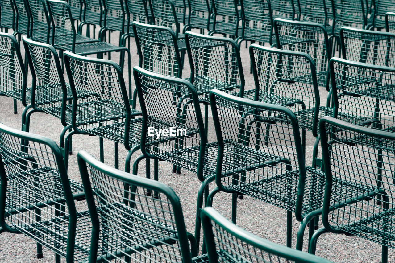 Full frame shot of empty chairs on footpath