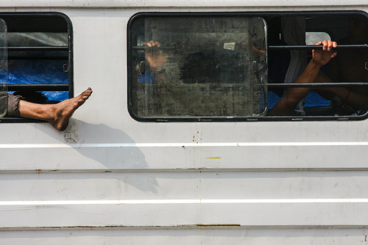 View of passengers through bus window