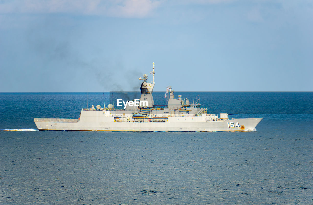 SHIP IN SEA AGAINST SKY