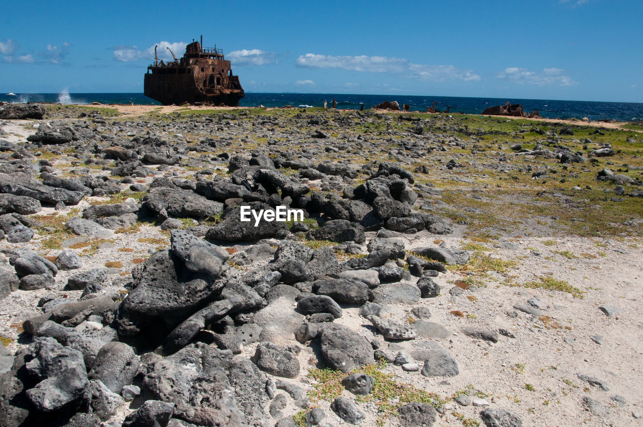 rock, sky, sea, shore, land, coast, water, nature, beach, terrain, ocean, scenics - nature, geology, cliff, no people, travel destinations, landscape, environment, beauty in nature, cloud, day, travel, outdoors, tranquility, architecture, coastline, blue, horizon, tranquil scene, tourism, non-urban scene, horizon over water