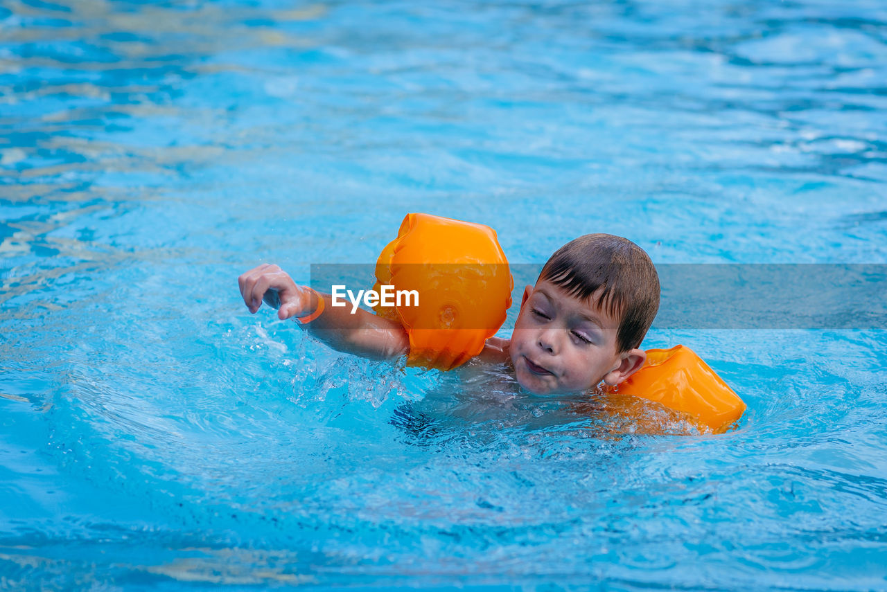 Boy playing in swimming pool