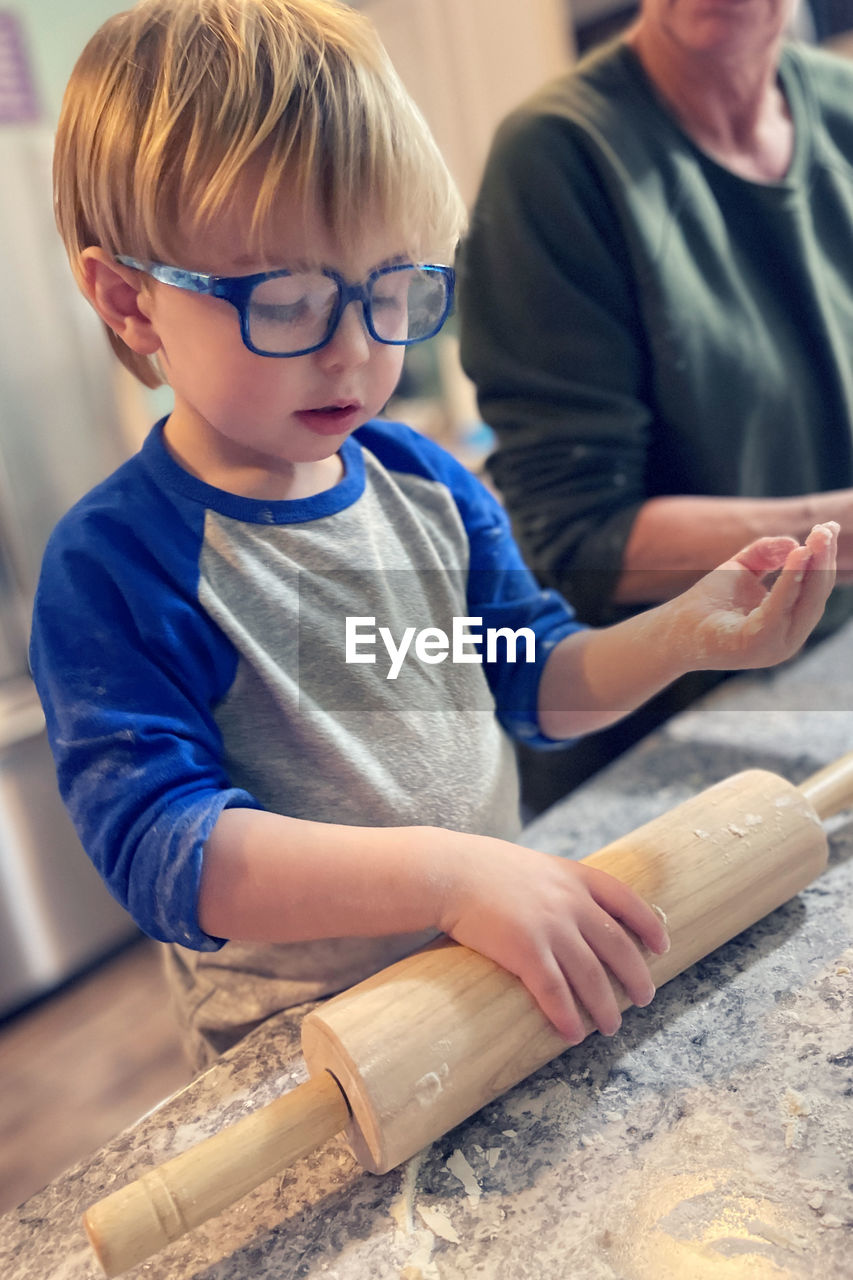 Toddler boy learning how to make cookies