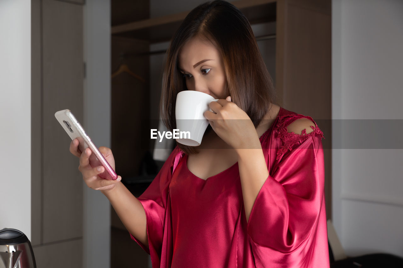 Young woman holding coffee cup