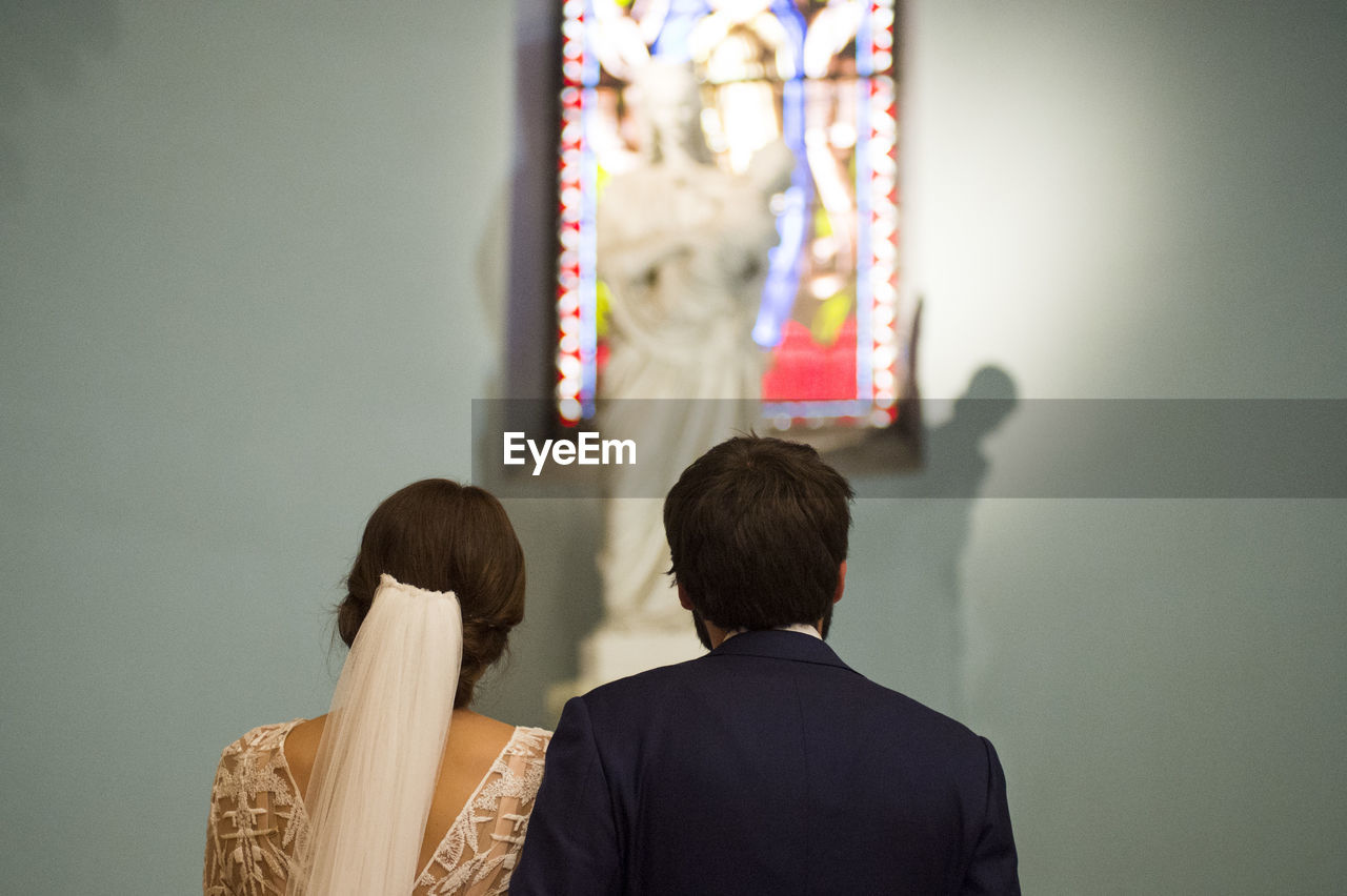 Rear view of couple standing in church