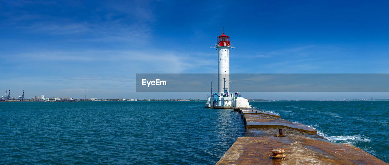 Lighthouse at the entrance to the harbor of odessa seaport, on a sunny summer day