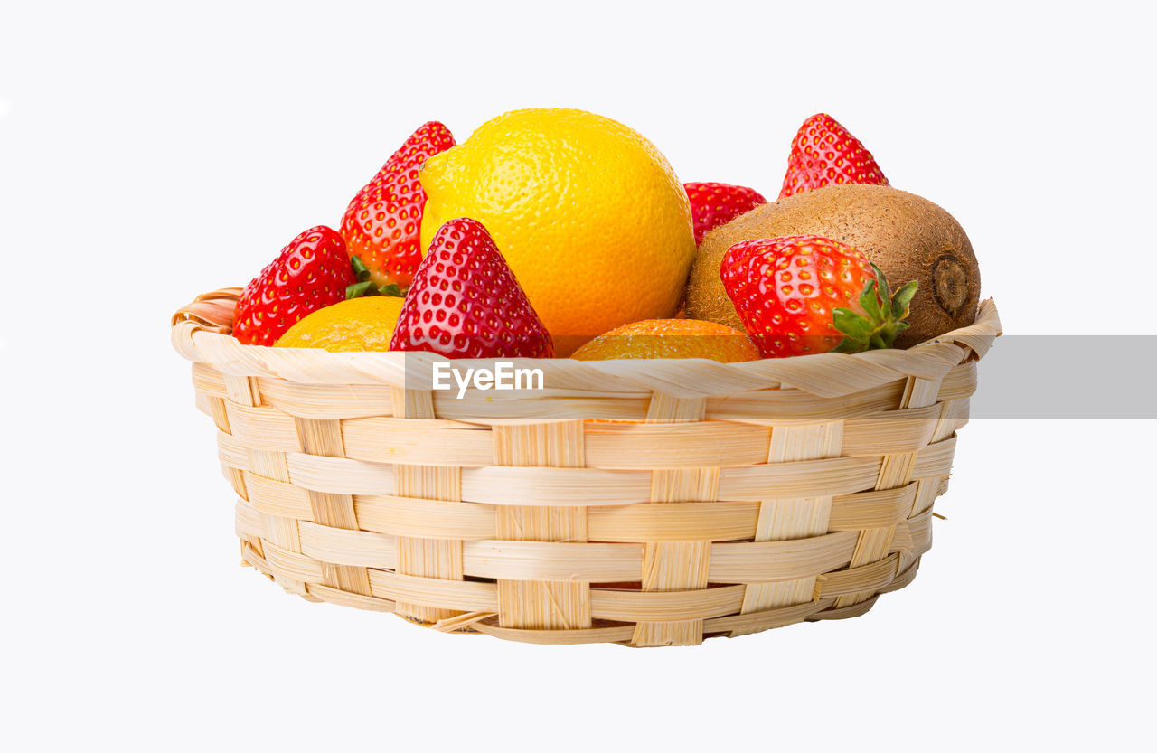 CLOSE-UP OF STRAWBERRIES IN BASKET