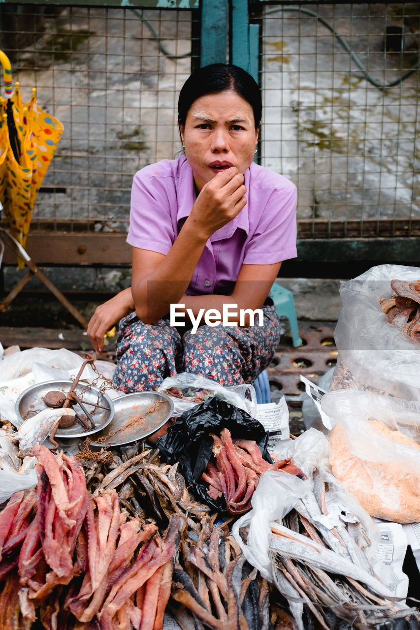 Woman holding fish at market