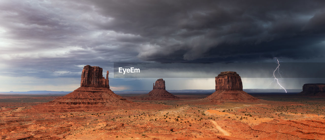 A thunderstorm with dramatic clouds and lightning sweeps through monument valley, arizona