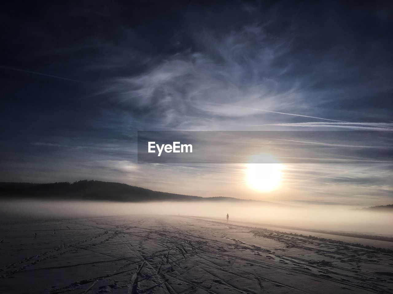 Scenic view of snowy landscape against sky during sunset