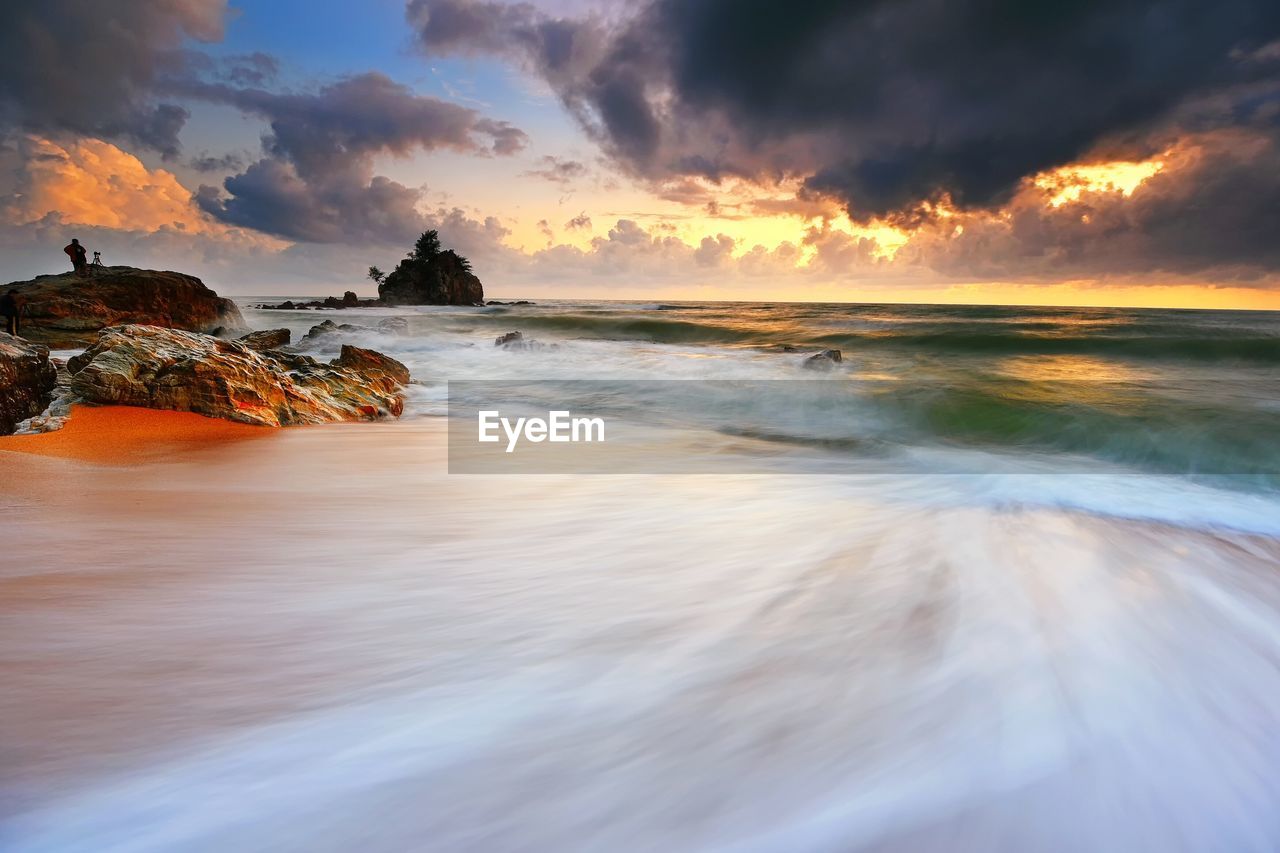 Long exposure of sea and rocks at dusk