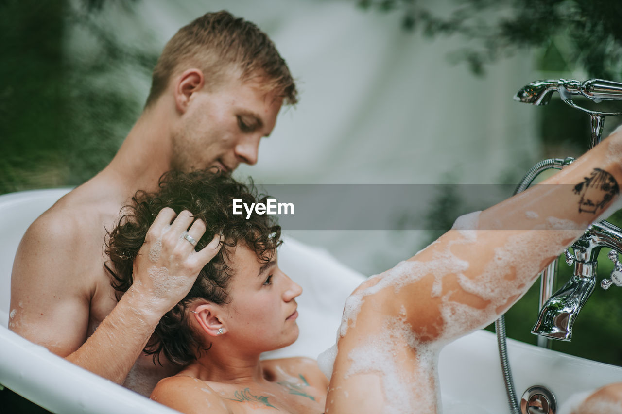 Portrait of father and son in bathroom