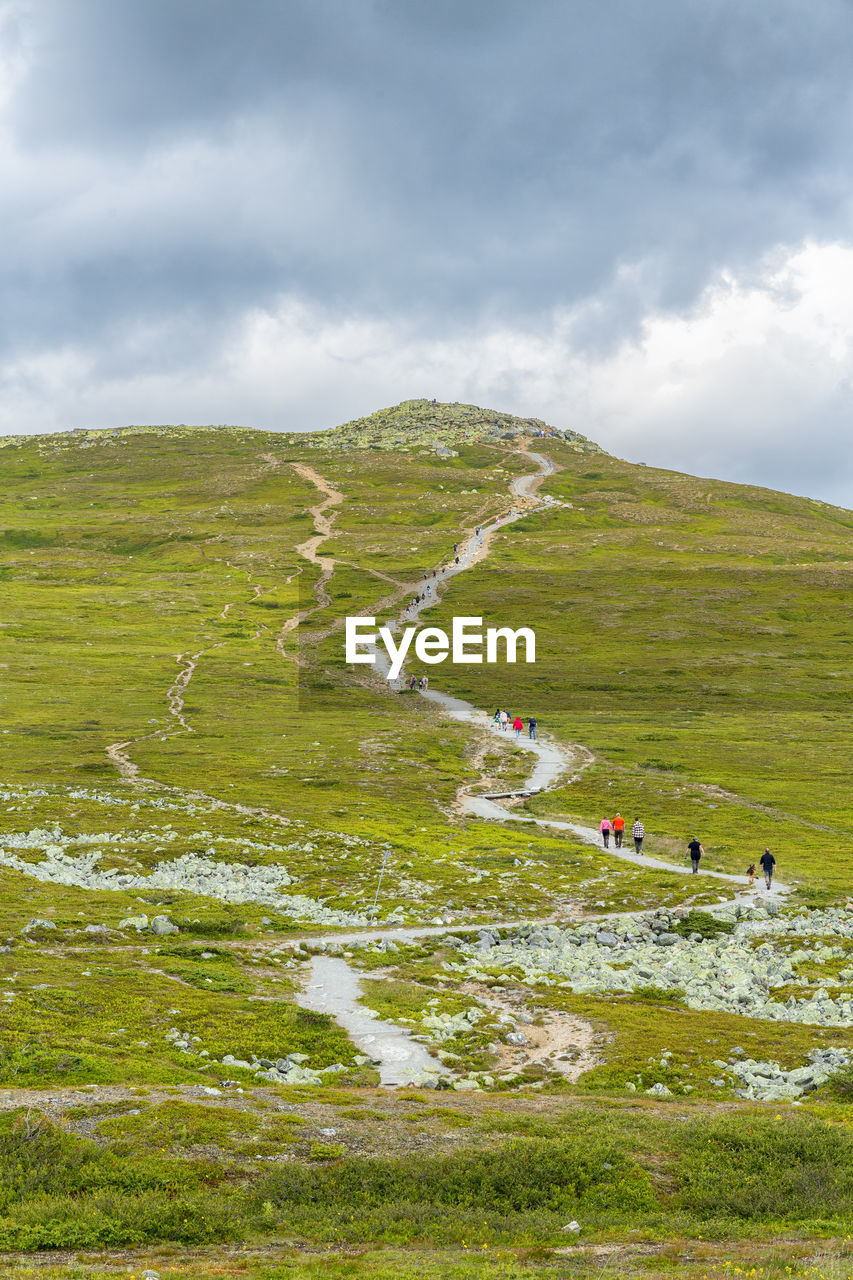 People heading to a mountain peak